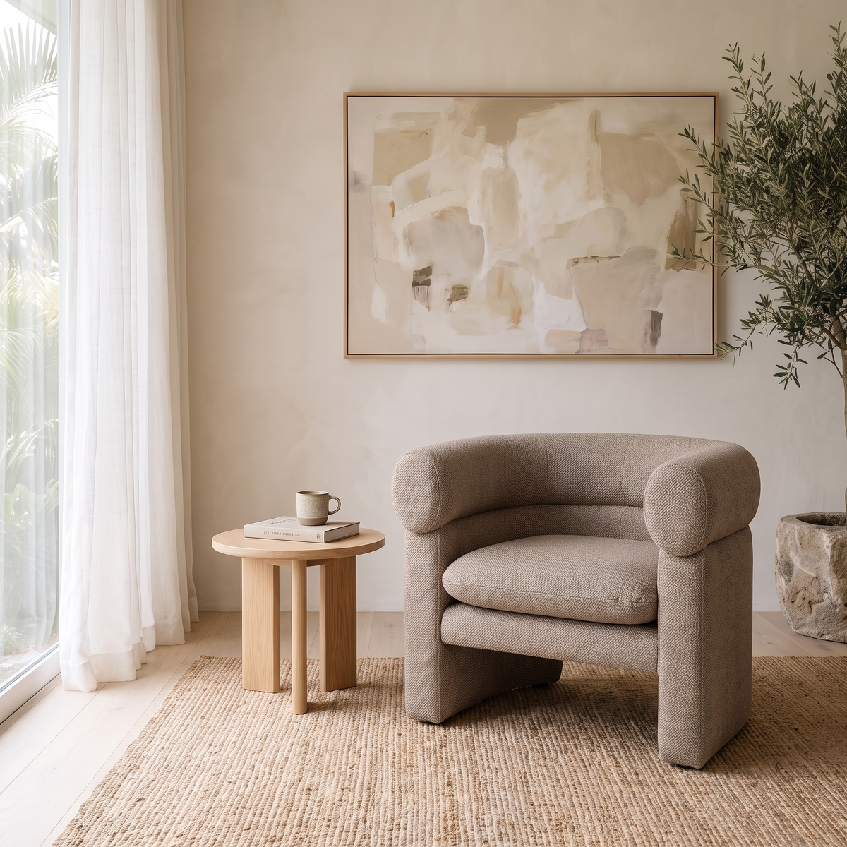 Pillar Armchair in Taupe by the window with a side table