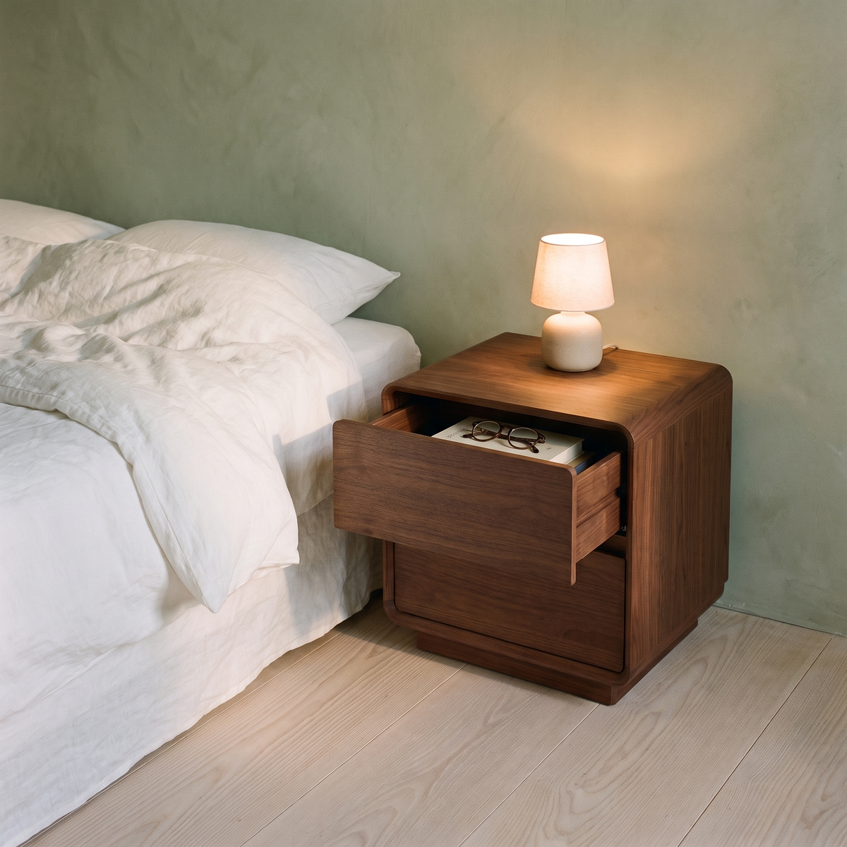 Wailea Nightstand beside a bed with the top drawer open