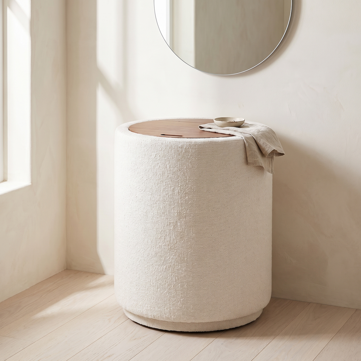 Laie Round Vanity in a bedroom corner beneath a round mirror